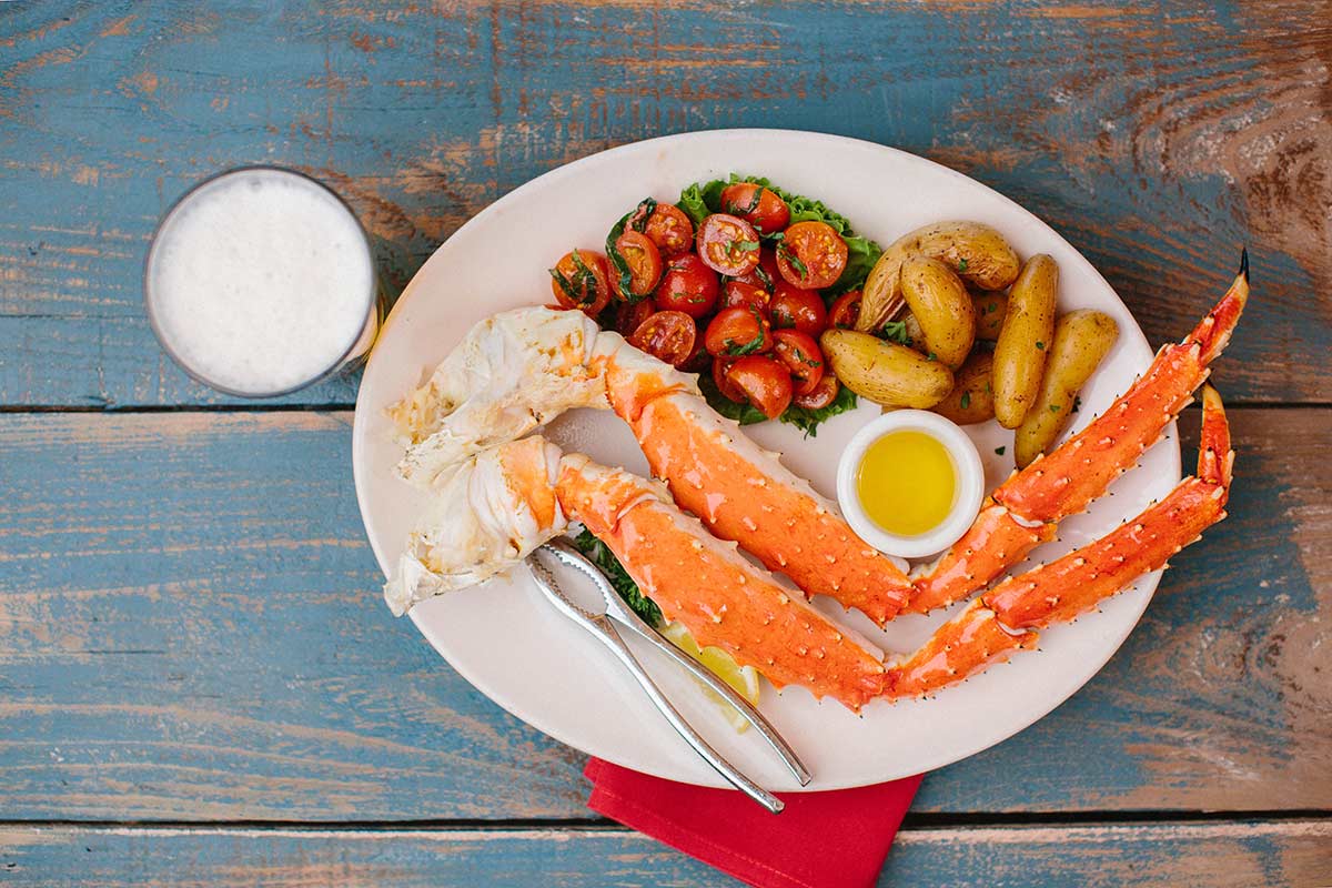 King crab legs with potatoes and tomatoes